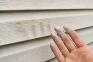 Chalky oxidation residue on vinyl siding revealed after pressure washing in Roanoke, VA