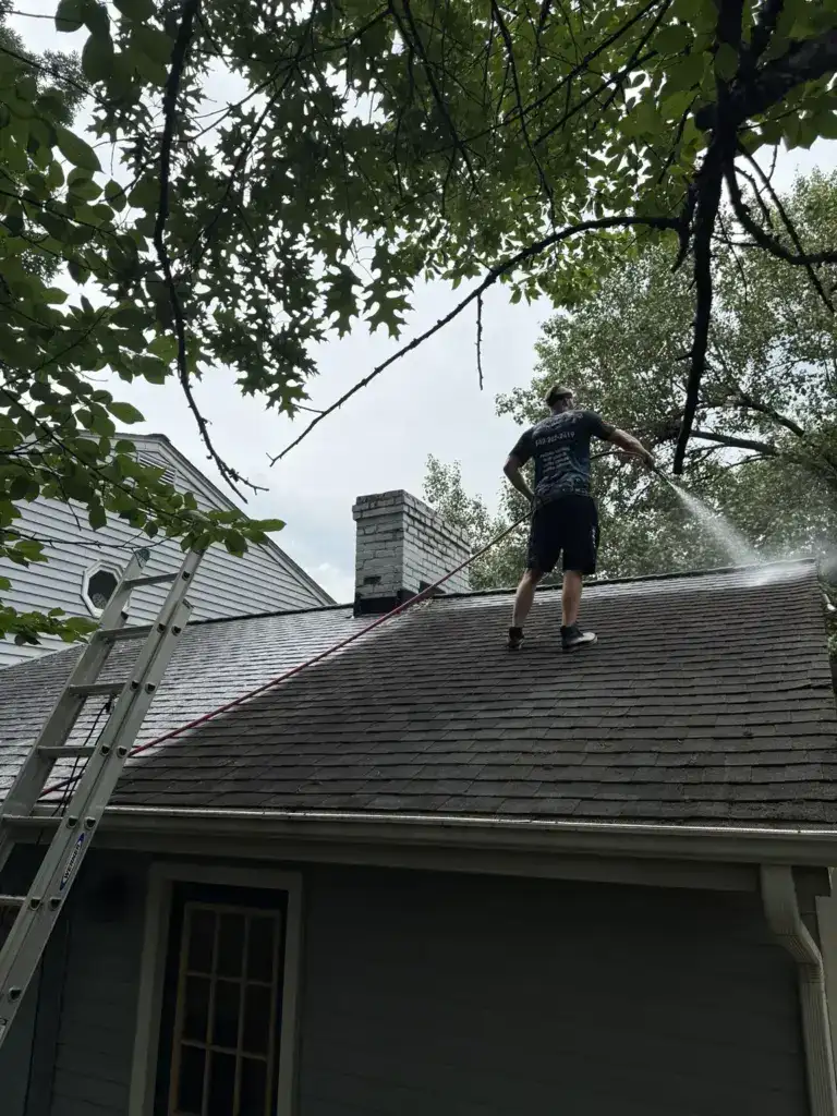 Pressure washing in Roanoke, VA by Pro Pressure Washing Solutions cleaning a residential roof using homeowners outdoor water supply in Roanoke, VA.